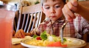 Child Eating Food from Plate