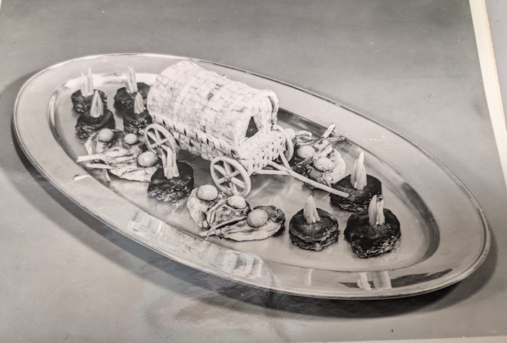 A silver platter with food on it.