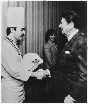 A person shaking hands with a chef.