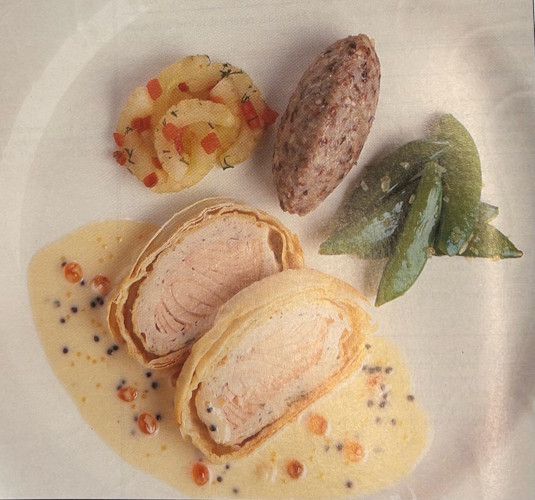 A plate of food with a sauce and vegetables.