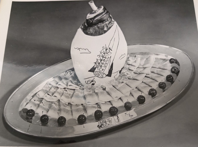 A plate of food with a picture of a ship on it.