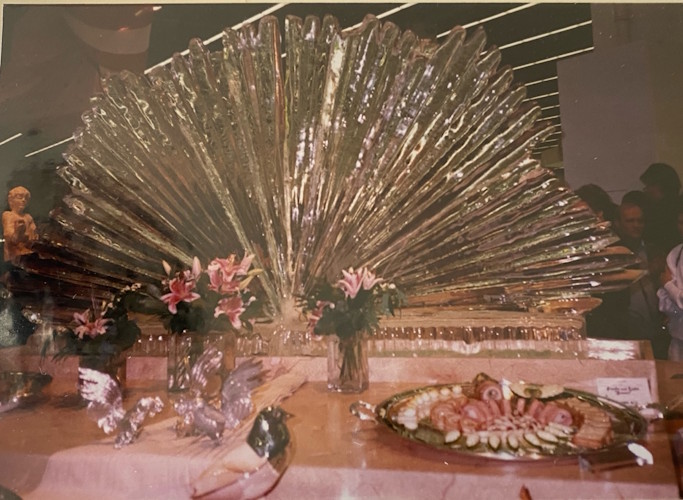 A table with a large glass sculpture.