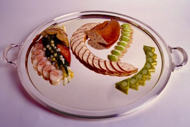 A plate of food on a white surface.