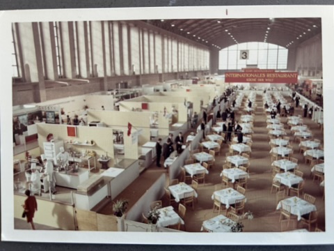 A large room with tables and chairs.