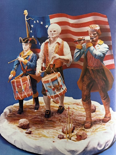 A statue of a group of soldiers playing instruments.