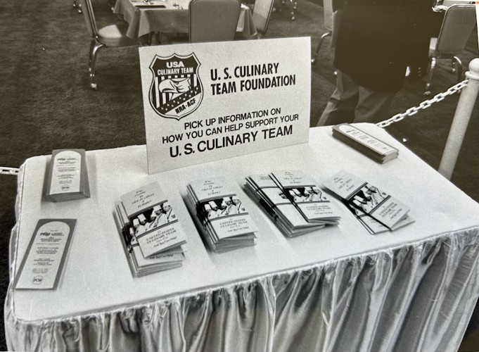 A table with a sign and a couple of cards.