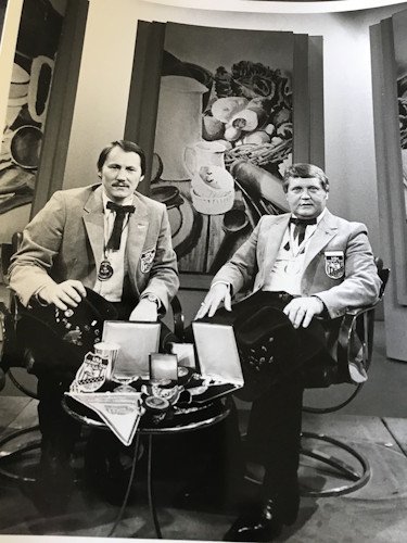 A couple of men sitting in chairs.