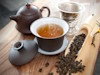 Teapot and cup containing tea