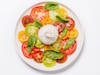 Plate of burrata and tomato slices